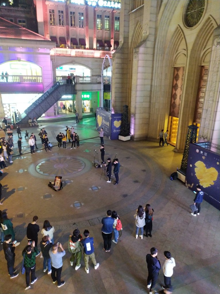 Street performers in front of the giant fake church in Guanggu, Wuhan in 2019.