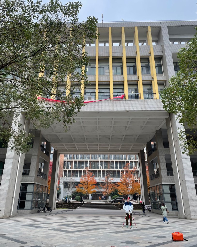 This photo depicts a Chinese surveying student at Wenhua College in Wuhan, 2020.