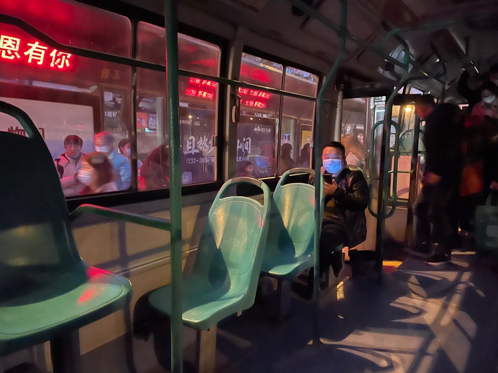 This photo shows masked bus riders in China in 2020.
