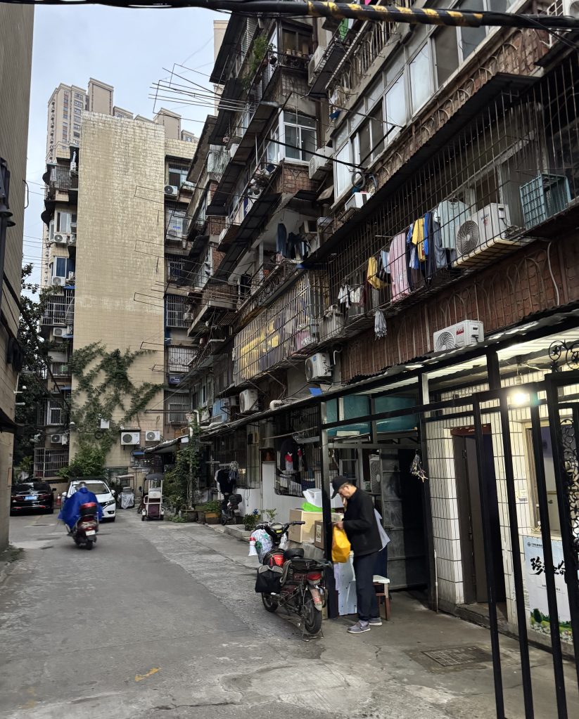 A photo of a man in a residential courtyard in Wuhan, China in 2026.