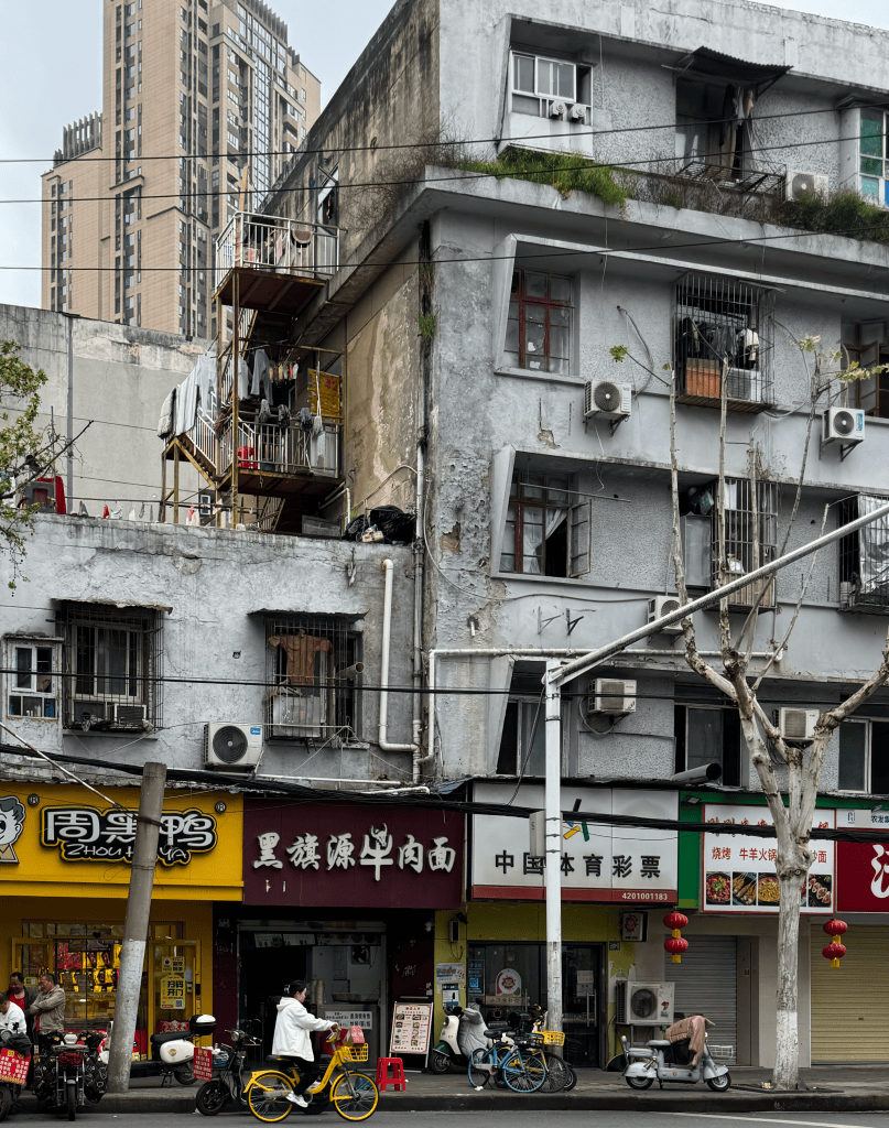 This is a photo of apartments and restaurants in Wuhan, China in 2026. Housing in China. 