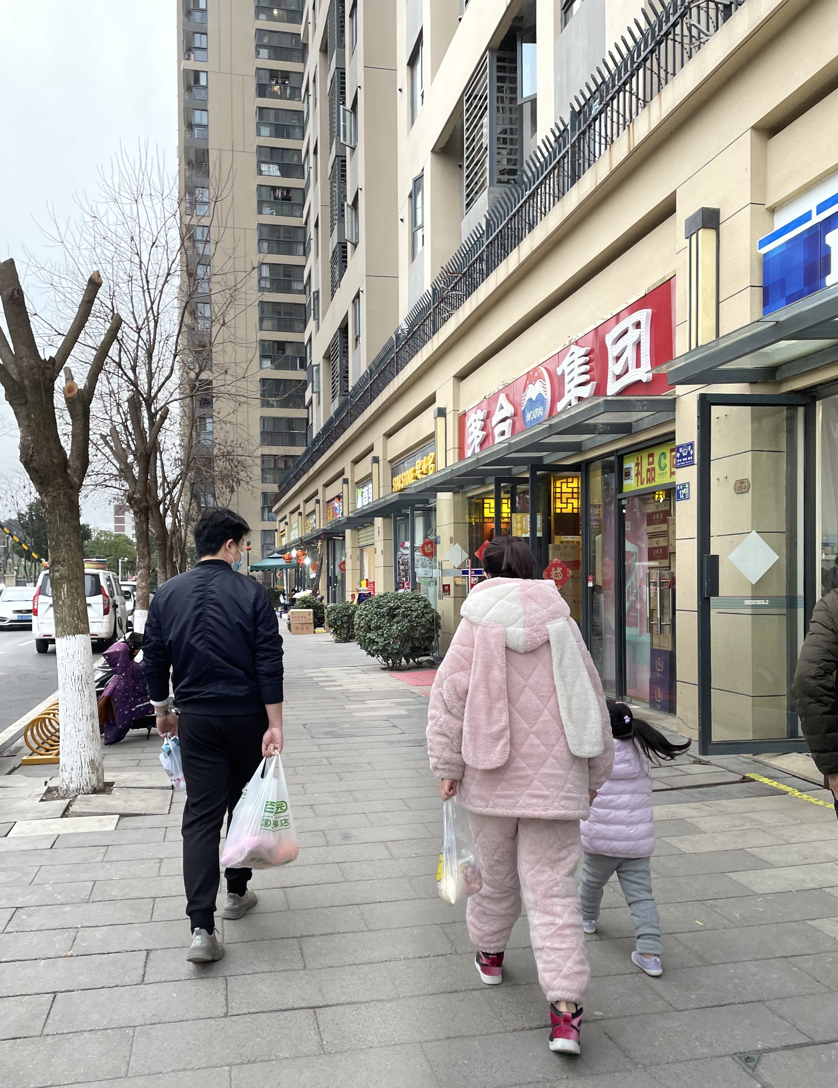This is a photo of a Chinese woman dressed in bunny rabbit pajamas walking in Wuhan in 2021.