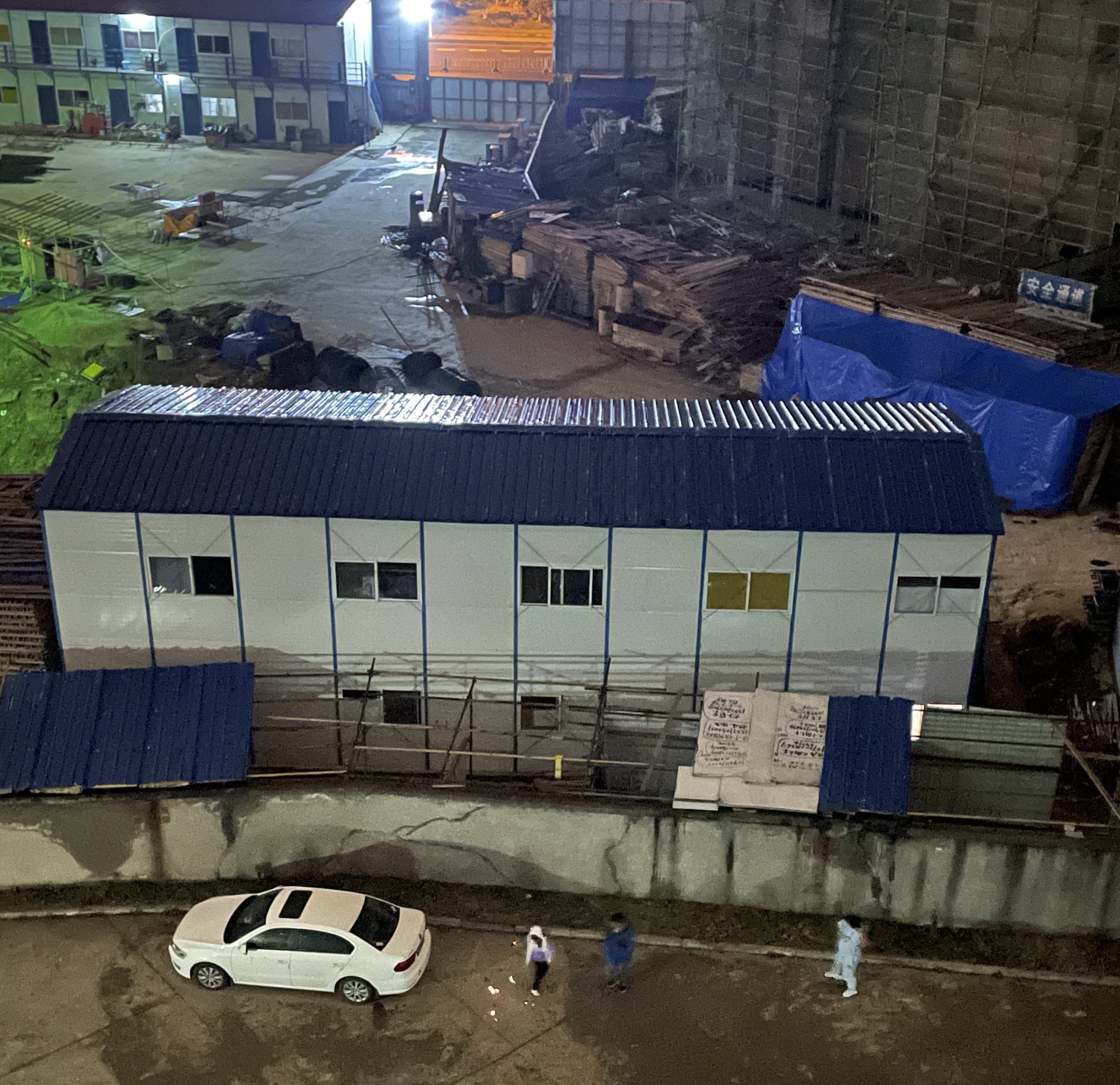 This is a photo of construction worker "dormitories" on the site of a future apartment complex. The workers have to spend years living in these makeshift buildings while they build. Photo from 2021.